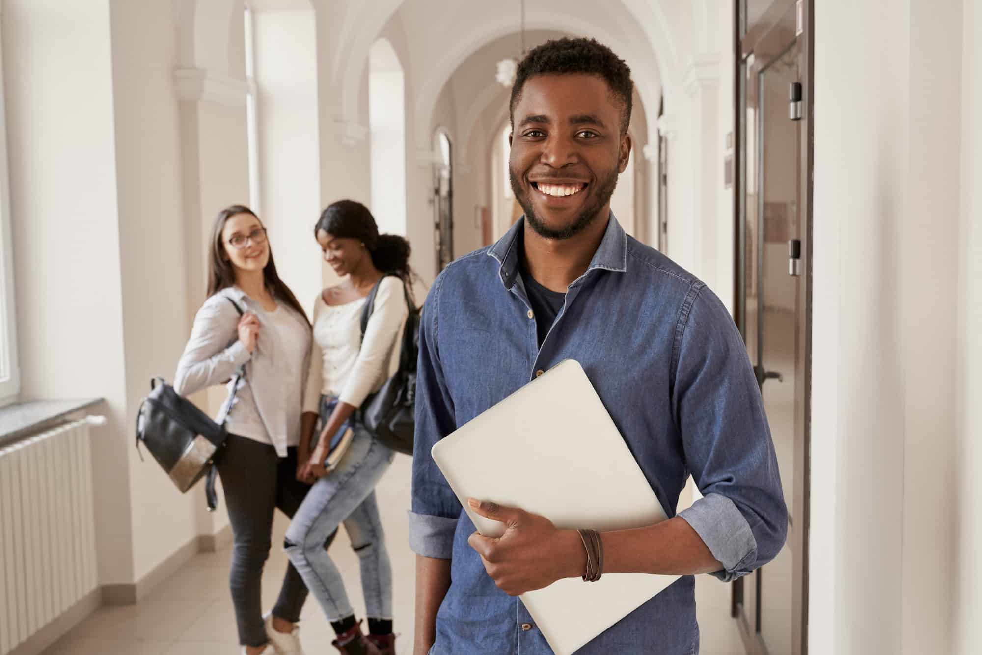 Positivity African student wearing shirt holding notes